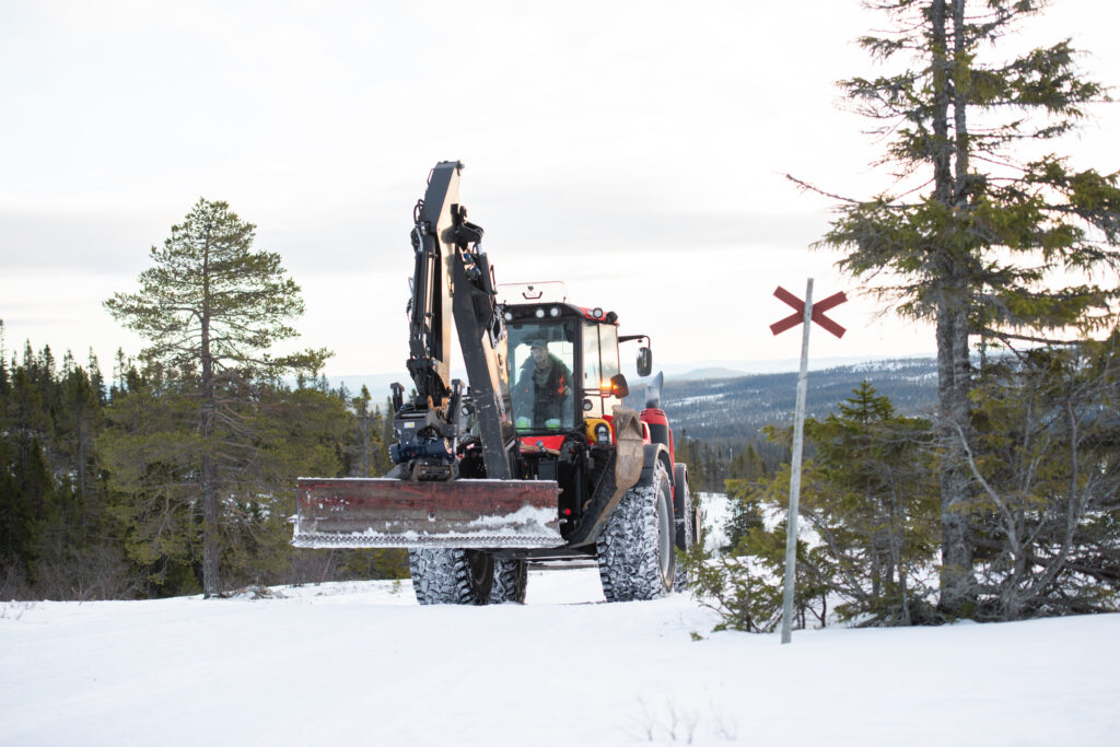 Man in an tractor in the north of Sweden