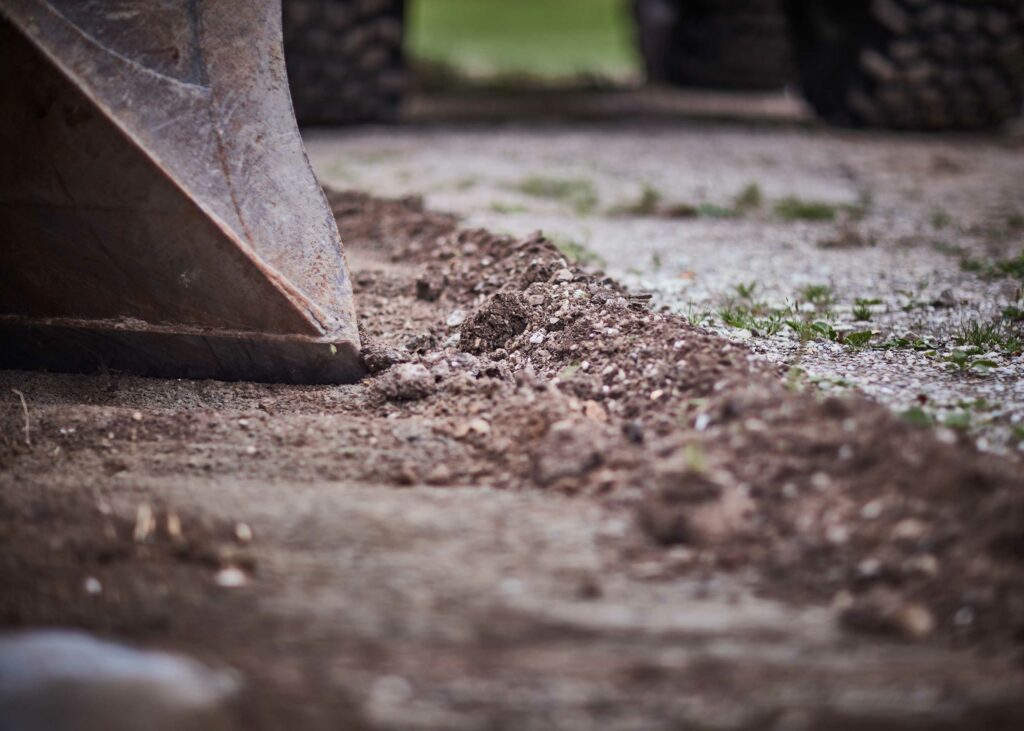 Excavator bucket doing some leveling of soil in Sweden