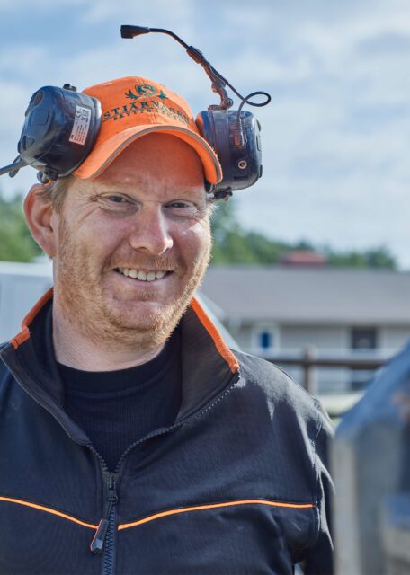 man with orange hat and beard smiling