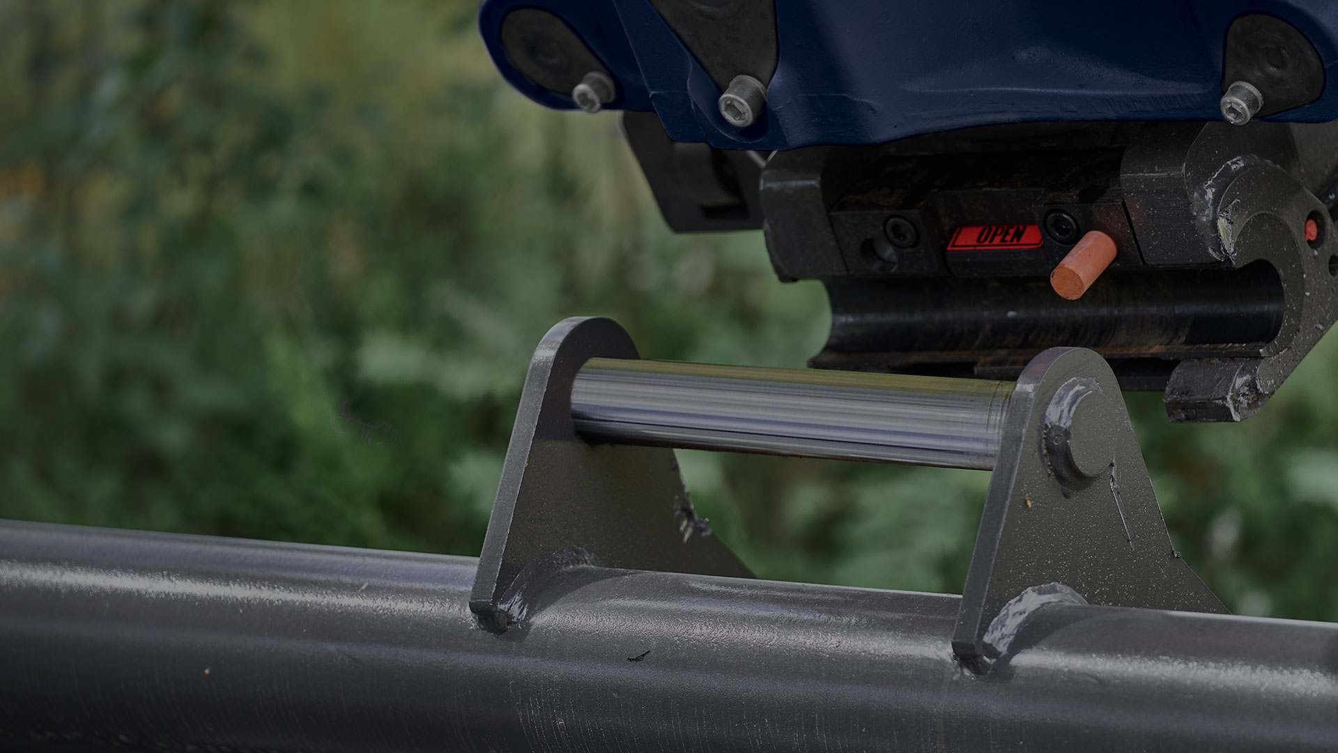 Quick coupler and excavator bucket outdoors