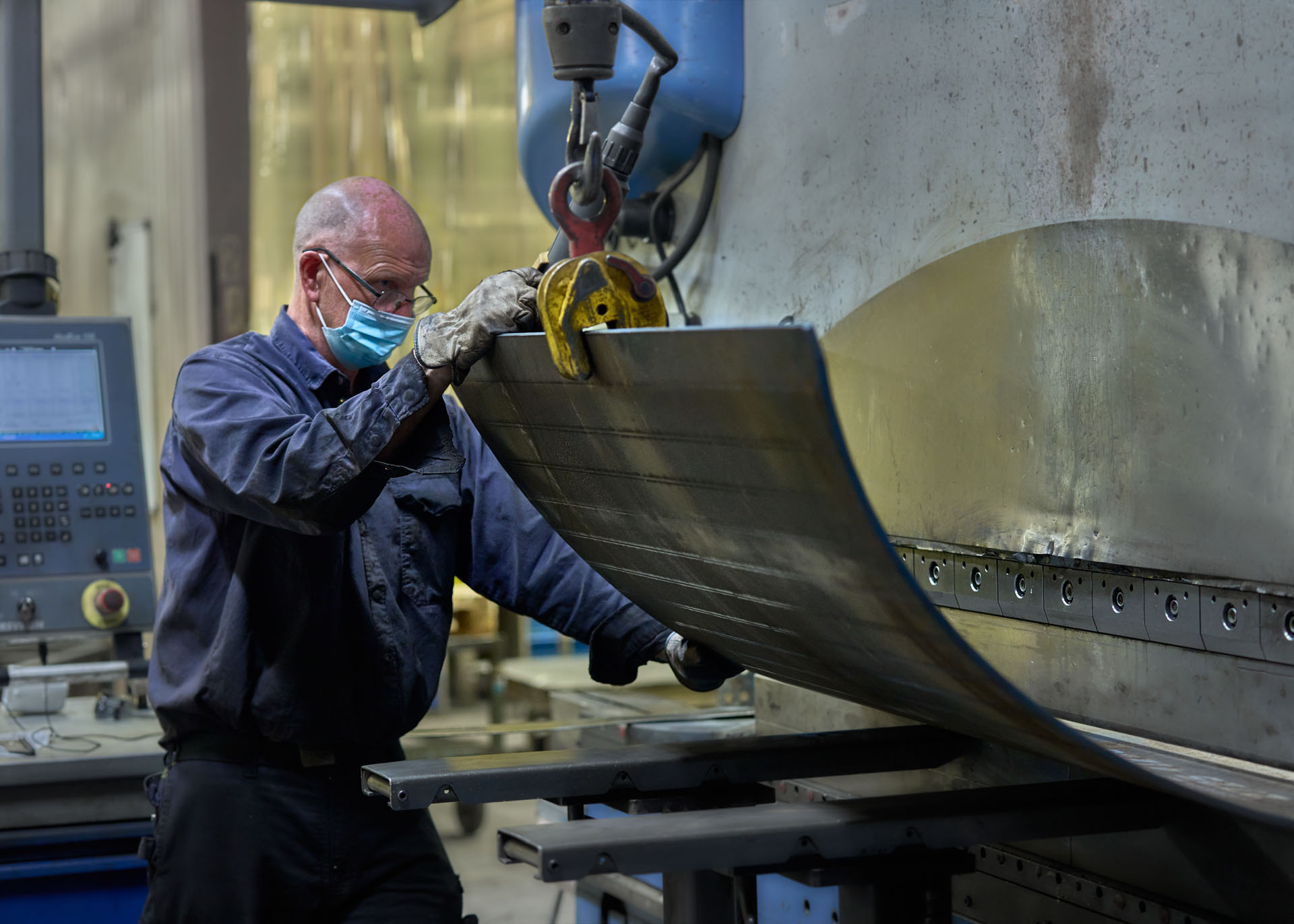 Man manufacturing a bucket for an excavator