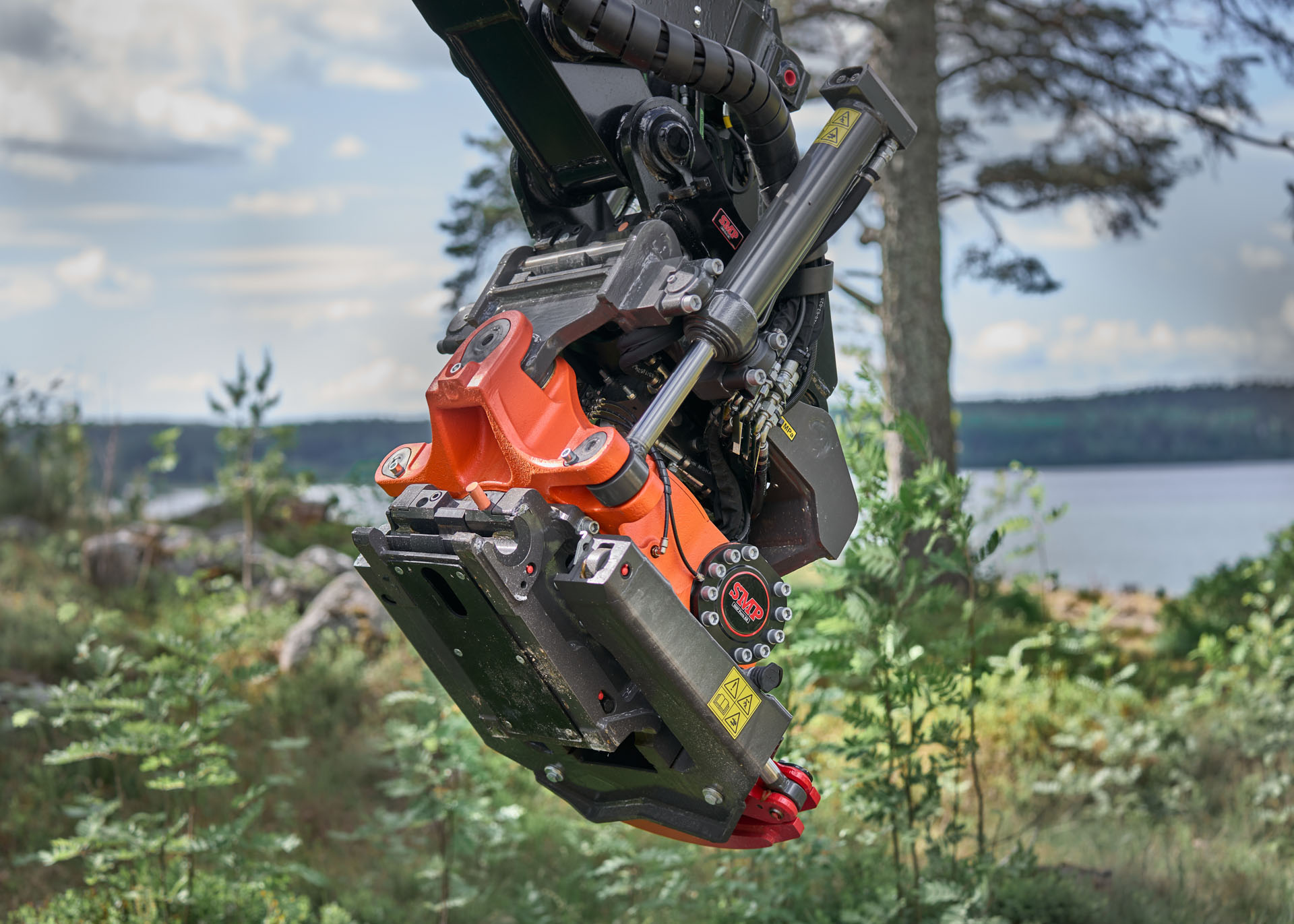 Orange quick coupler in a lovely landscape in Sweden next to a lake